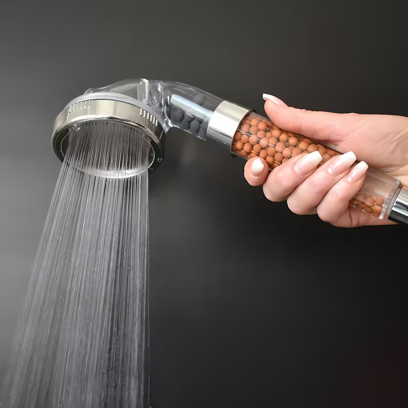 Skaidri rankinė dušo galvutė Rav Slezak su mikro purkštukais ir filtravimo mineraliniais akmenėliais, Ø 80 mm.