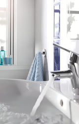Chromuotas kabliukas chalatui Grohe Essentials su paslėptu tvirtinimu ant apvalios sieninės plokštelės.